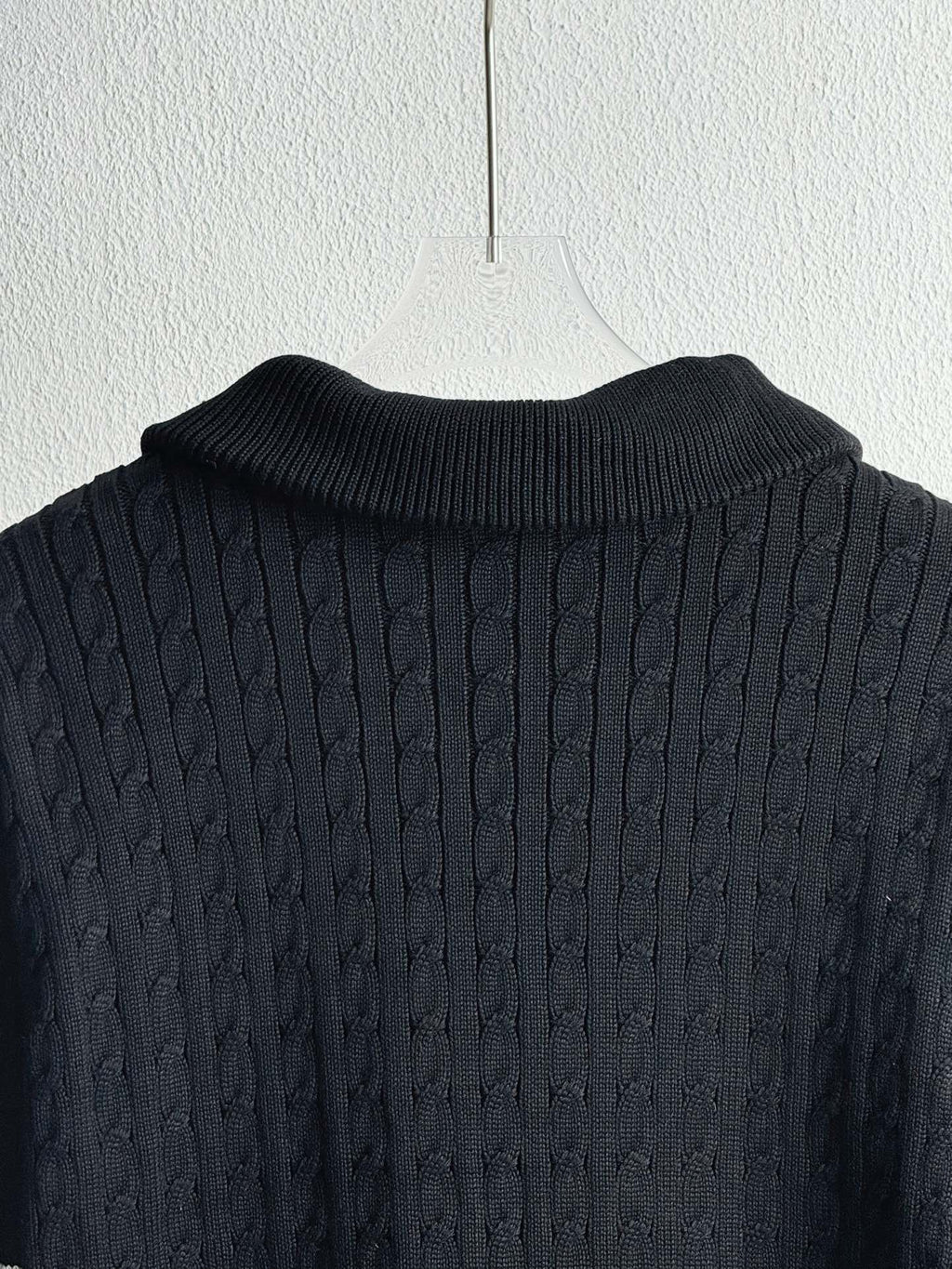 Dark navy knit collar and textured shoulders on a quilted puffer jacket