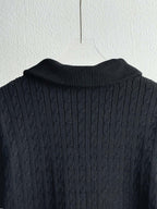 Dark navy knit collar and textured shoulders on a quilted puffer jacket