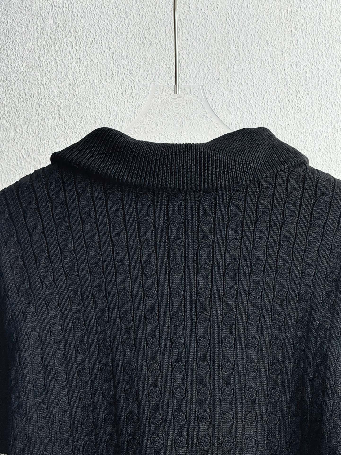 Dark navy knit collar and textured shoulders on a quilted puffer jacket