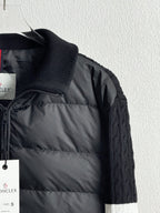 Dark quilted puffer jacket close-up with front quilting, zipper, and hanging tags