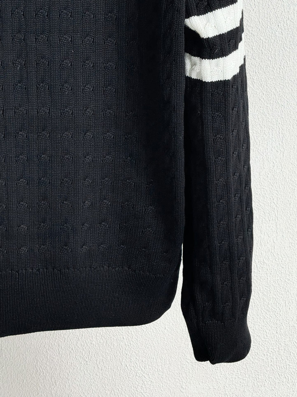 Long knit sleeve with textured cable pattern and ribbed cuff on puffer jacket
