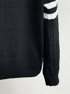 Long knit sleeve with textured cable pattern and ribbed cuff on puffer jacket