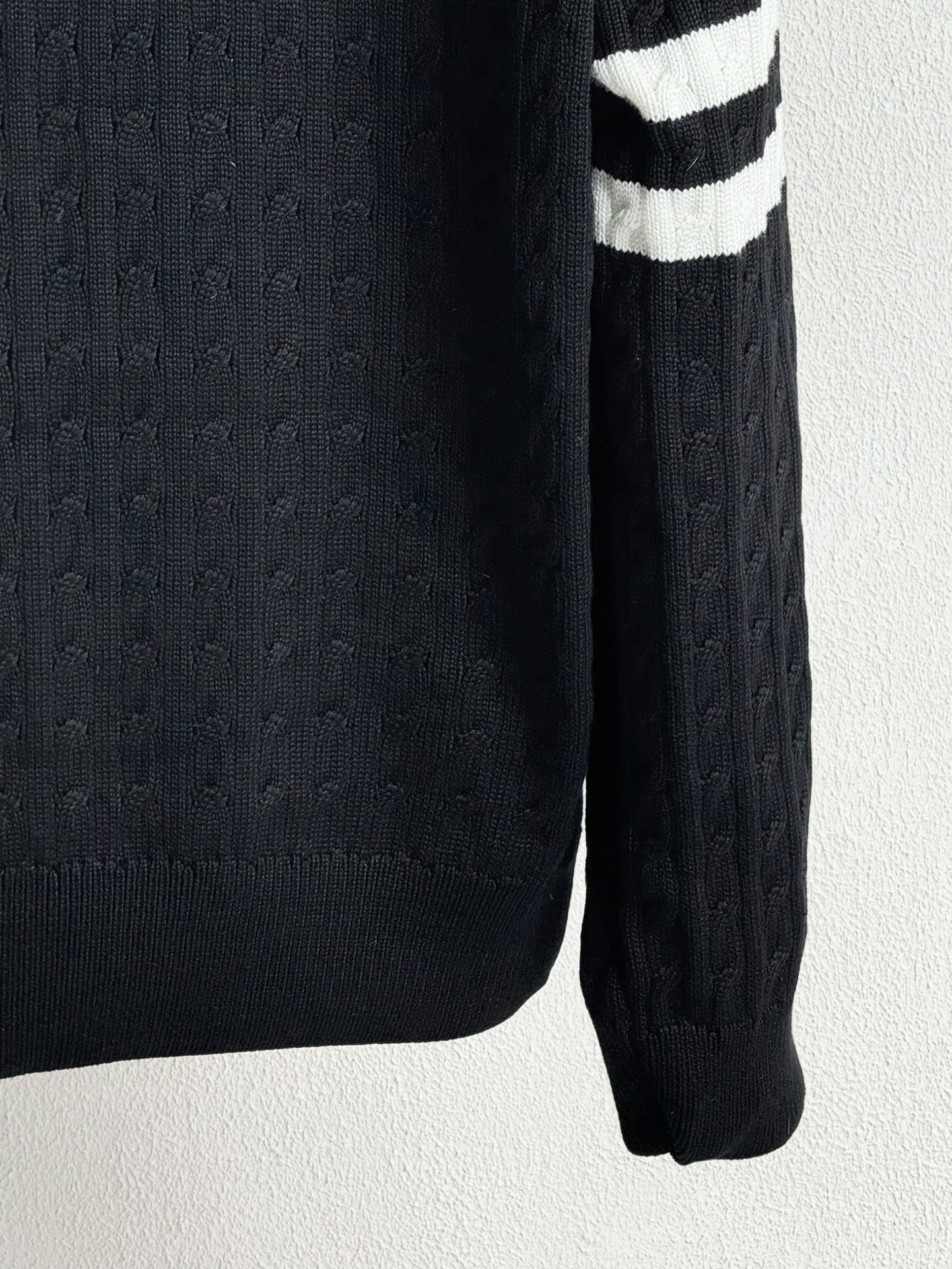 Long knit sleeve with textured cable pattern and ribbed cuff on puffer jacket
