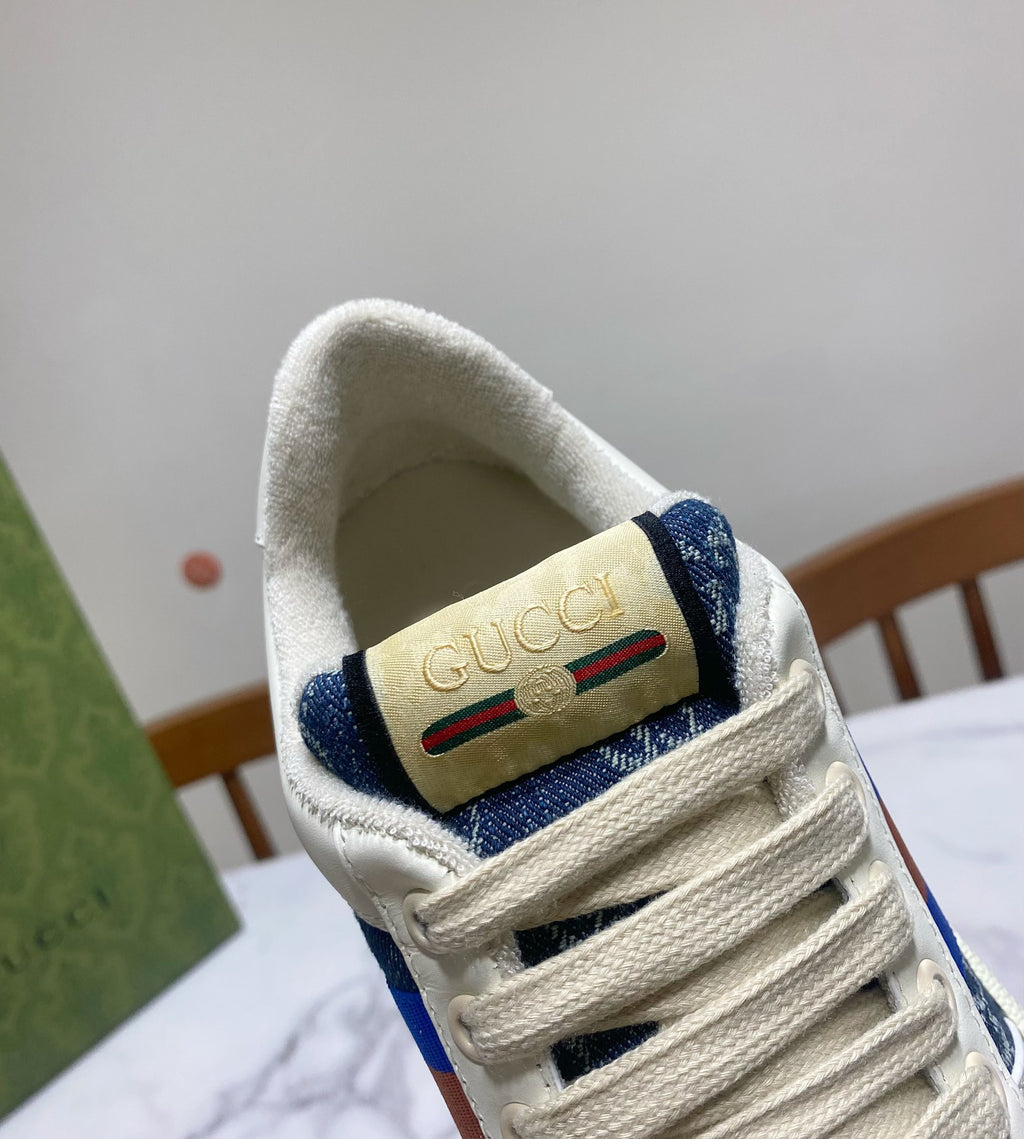 Gucci unisex sneaker tongue and heel detail, beige logo patch on blue patterned fabric