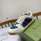 Gucci unisex low-top sneaker close side, white leather with blue patterned panel and multicolor web stripe