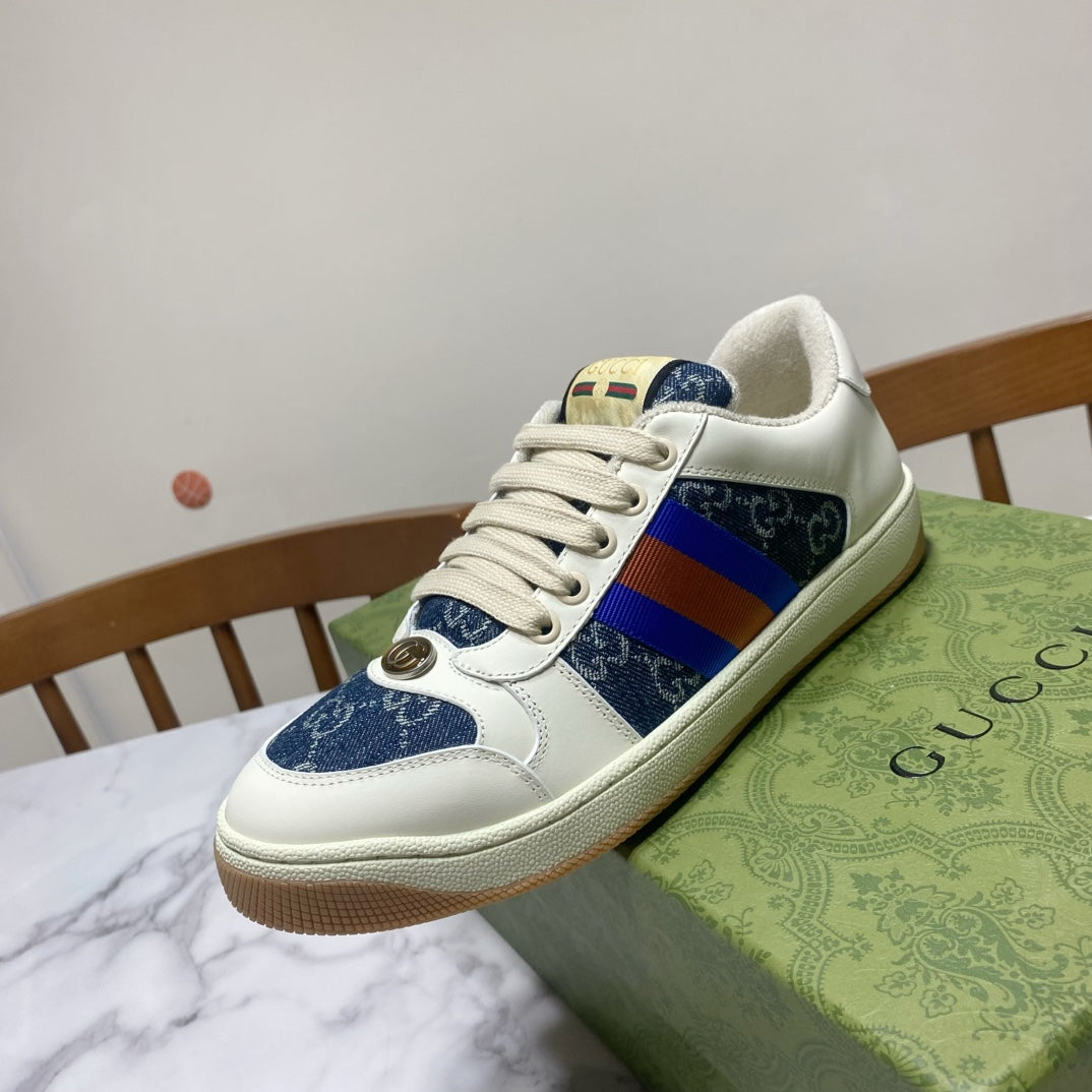 Gucci unisex low-top sneaker close side, white leather with blue patterned panel and multicolor web stripe