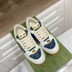 Gucci unisex low-top sneakers pair view, white leather with blue patterned side panels and web stripe