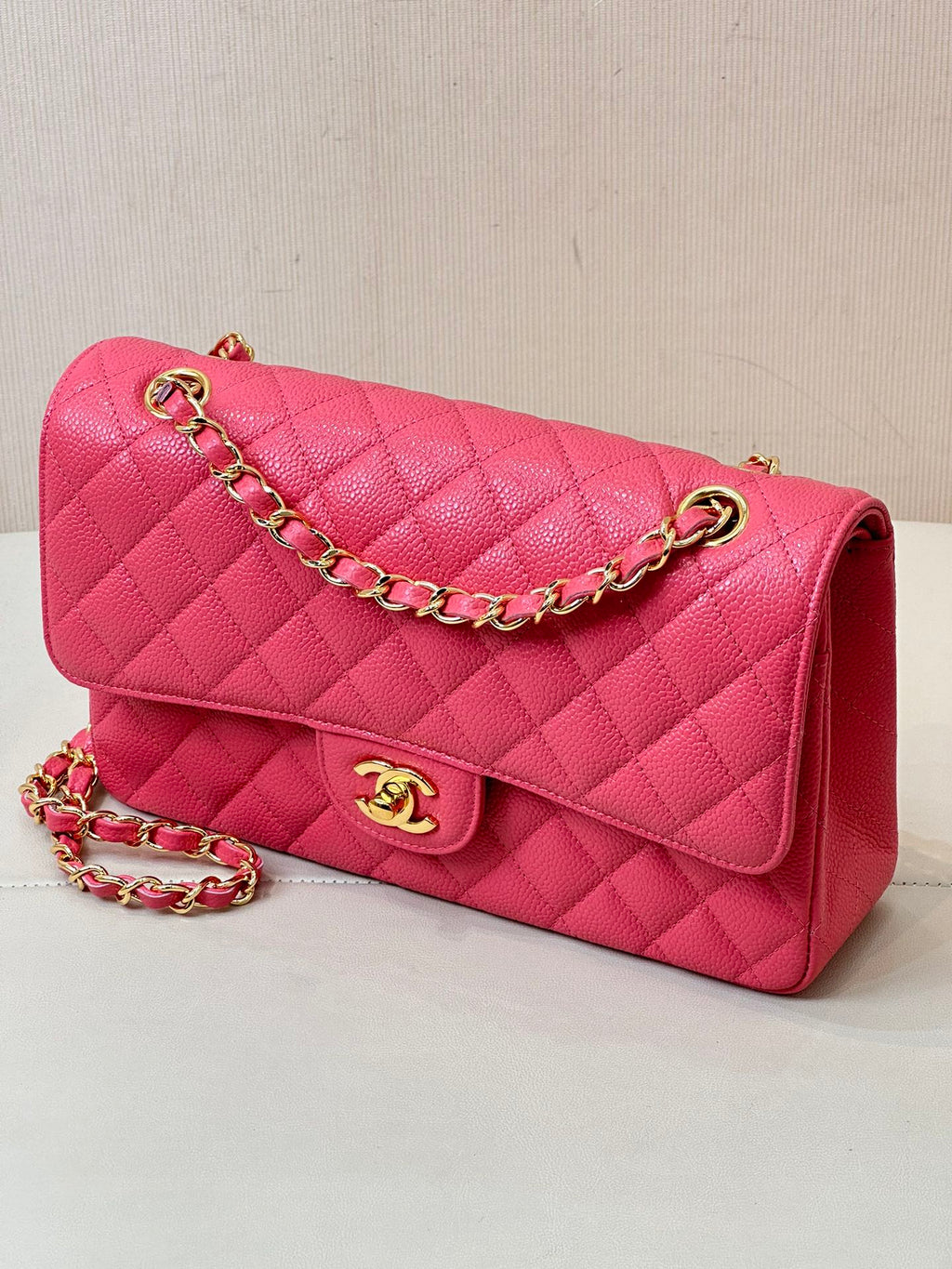 Fuchsia quilted leather shoulder bag with gold chain, front flap, and Chanel logo