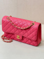 Fuchsia quilted leather shoulder bag with gold chain, front flap, and Chanel logo