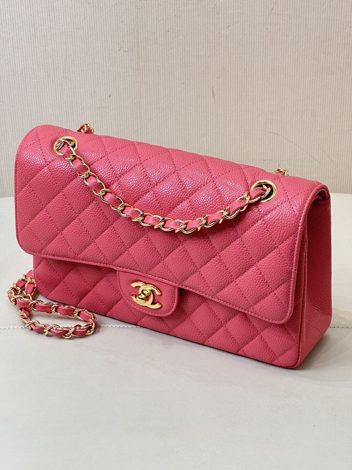 Fuchsia quilted leather shoulder bag with gold chain, front flap, and Chanel logo