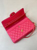 Fuchsia quilted leather handbag with flap closure, gold turn-lock, and chain strap