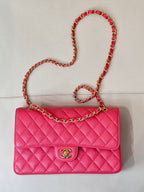 Fuchsia quilted leather flap shoulder bag with gold Chanel logo and chain strap