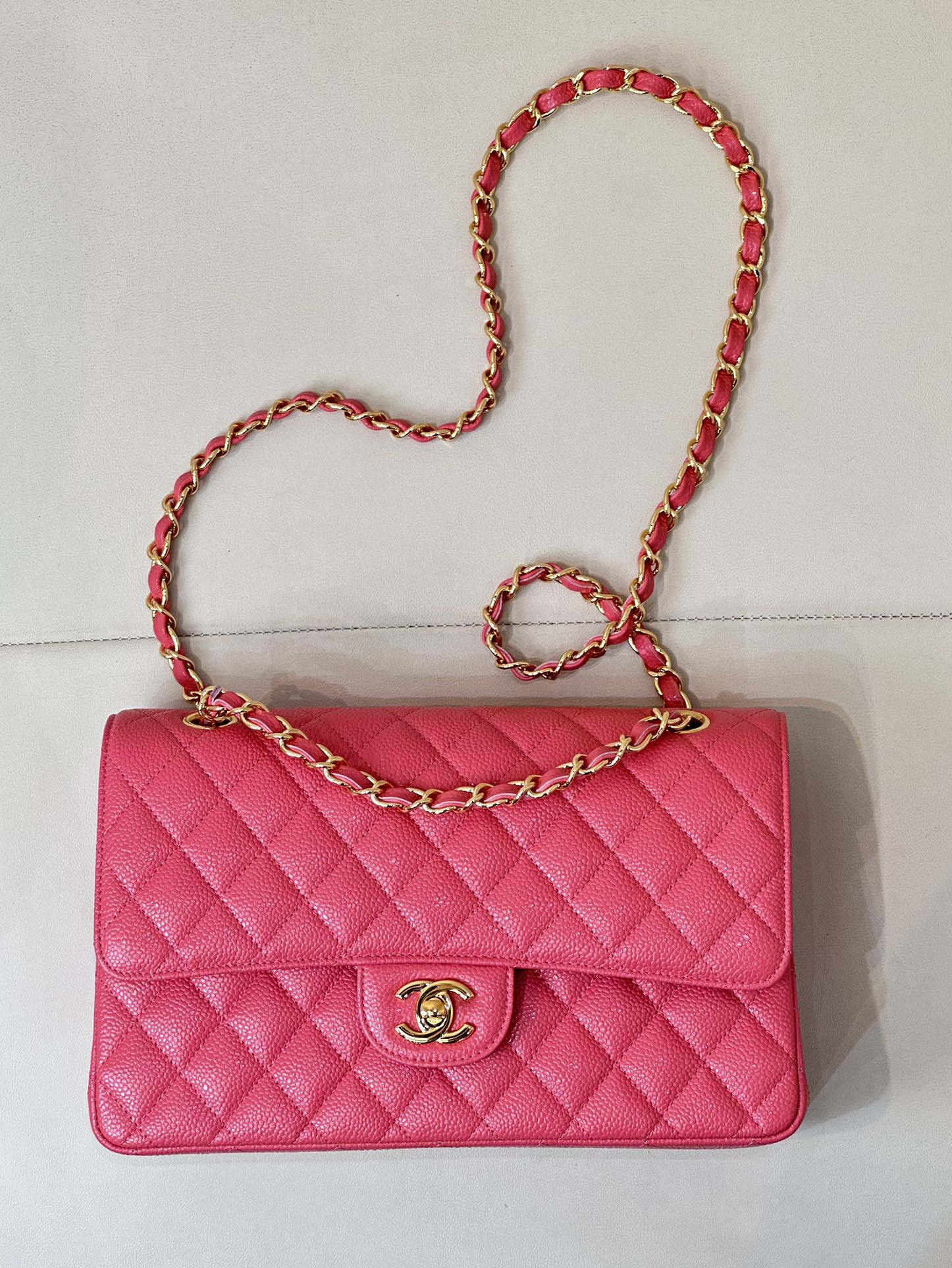 Fuchsia quilted leather flap shoulder bag with gold Chanel logo and chain strap