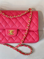 Fuchsia quilted leather flap shoulder bag close-up of gold Chanel logo and chain