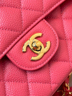 Fuchsia leather flap with gold Chanel logo and stitched flap edge