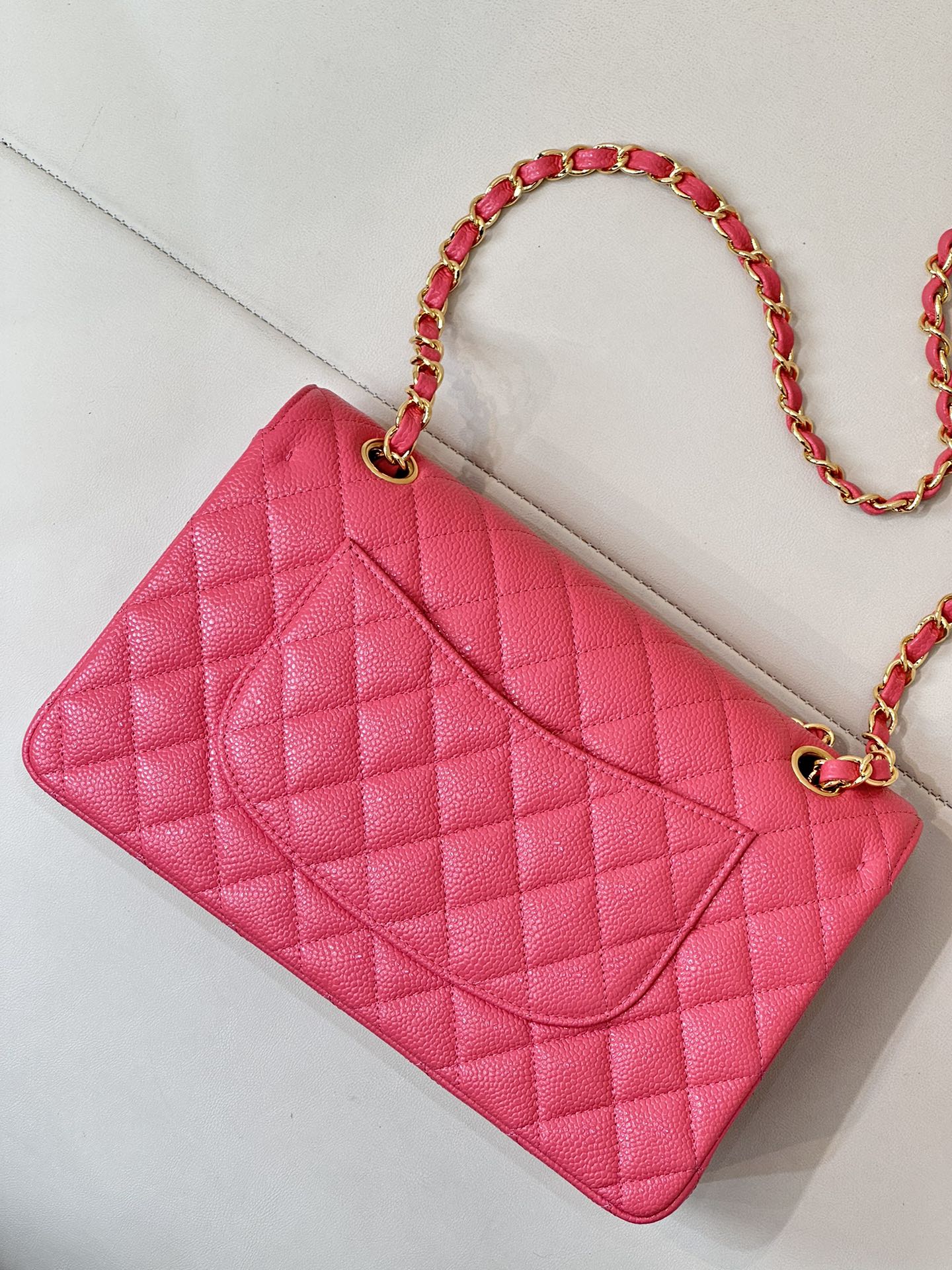 Fuchsia quilted leather mini bag with chain strap and diamond-pattern front flap
