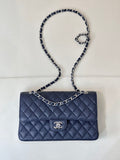 Quilted leather flap shoulder bag with chain strap and Chanel logo, dark navy blue.