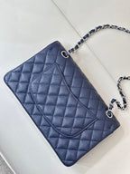 Quilted leather flap shoulder bag with chain strap, angled top view, dark navy blue.