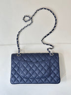 Quilted leather flap shoulder bag with chain strap, straight-on view, dark navy blue.