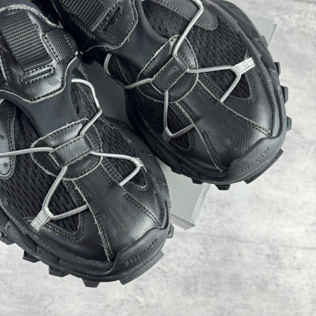Balenciaga unisex sneaker side view, black leather with silver laces and thick rubber sole
