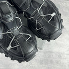 Balenciaga unisex sneaker side view, black leather with silver laces and thick rubber sole