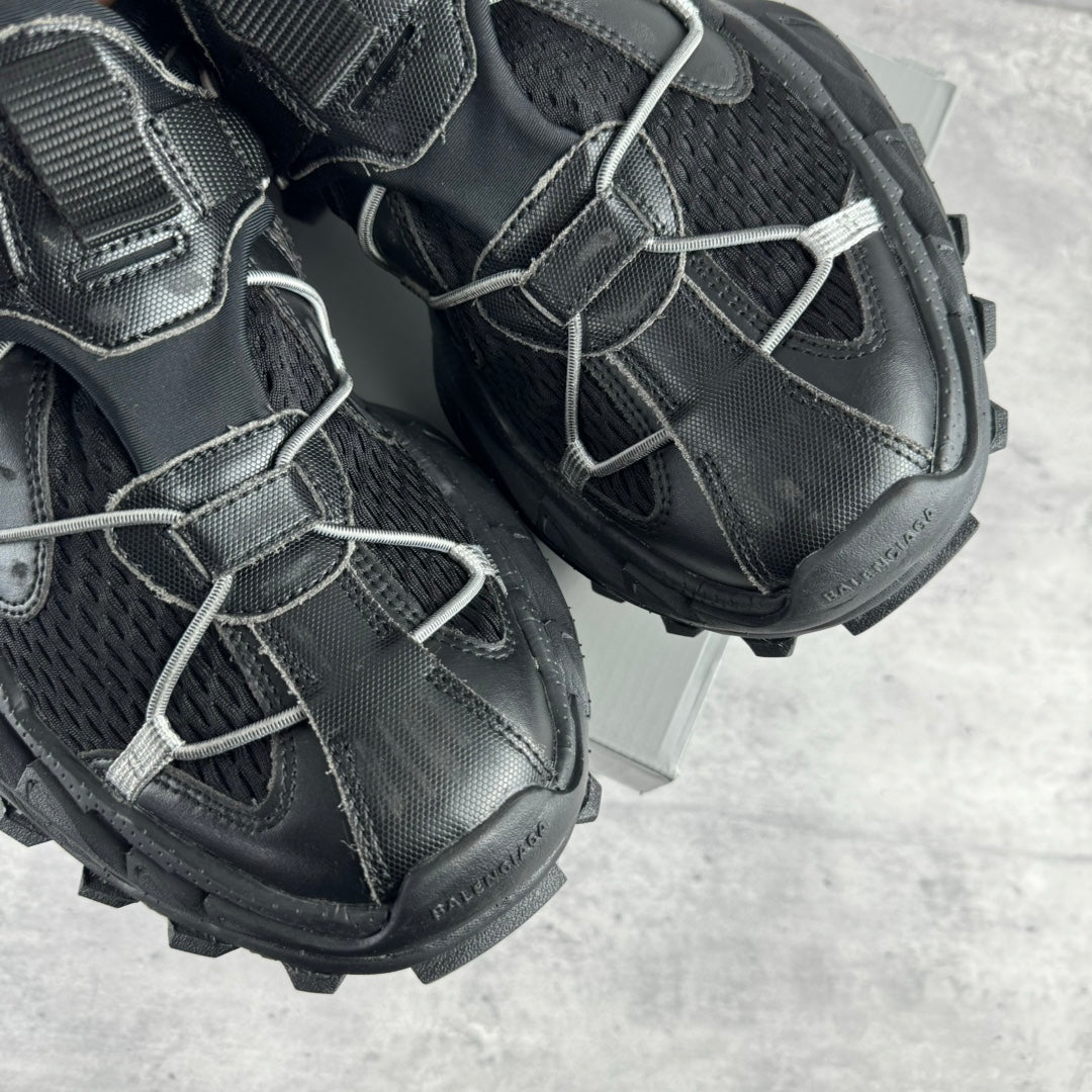 Balenciaga unisex sneaker side view, black leather with silver laces and thick rubber sole