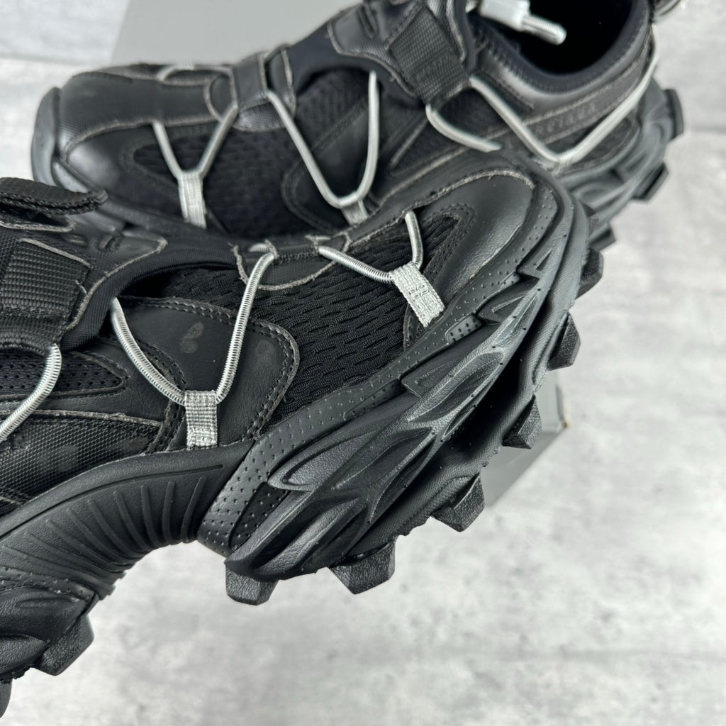 Balenciaga unisex sneaker detail, black mesh and leather panels with silver lace trim