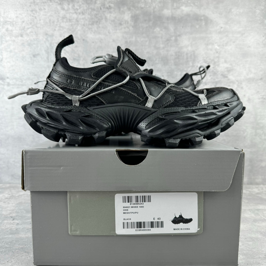 Balenciaga unisex sneakers on box, black upper with silver laces and raised trail sole
