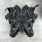 Balenciaga unisex sneakers front view, black lace-up design with chunky trail sole