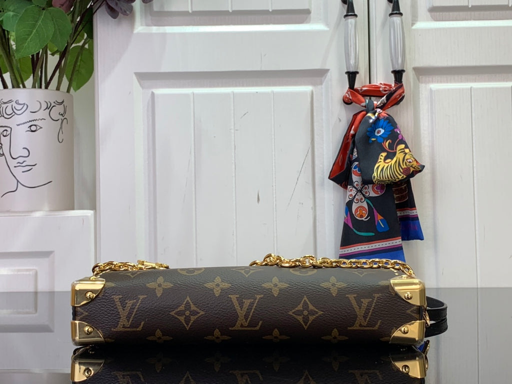 Louis Vuitton monogram handbag with gold hardware and chain strap details