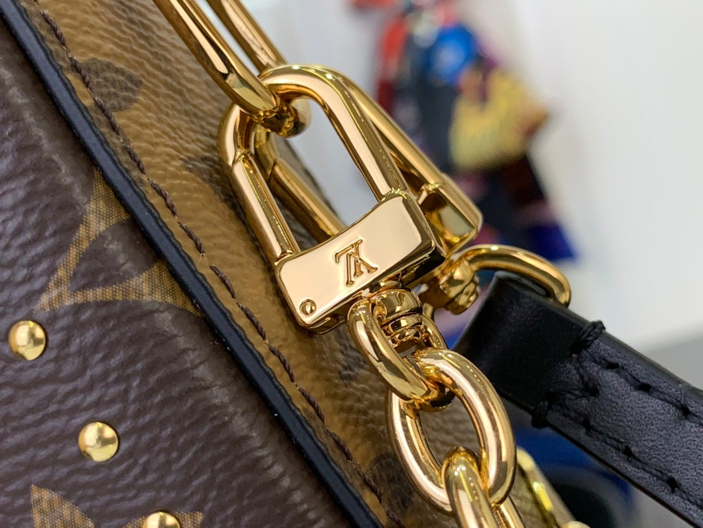 Louis Vuitton monogram bag clasp with gold chain connector and black strap
