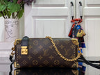 Louis Vuitton monogram crossbody bag with gold chain strap and dark leather trim