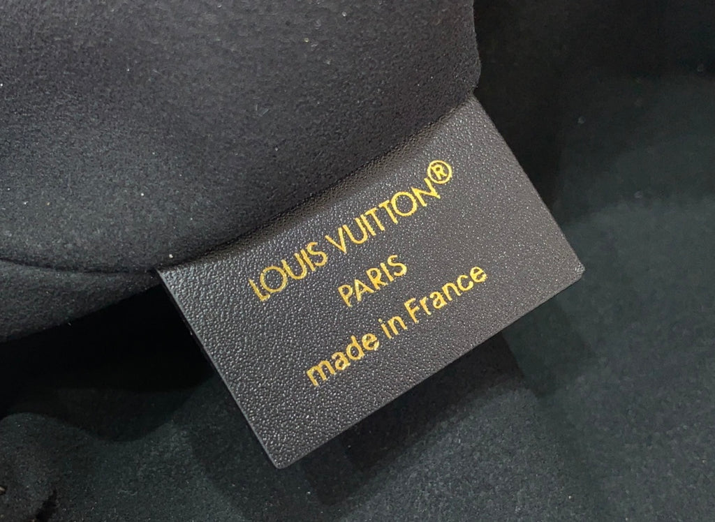 Louis Vuitton Paris made in France authenticity tag on gray fabric backing