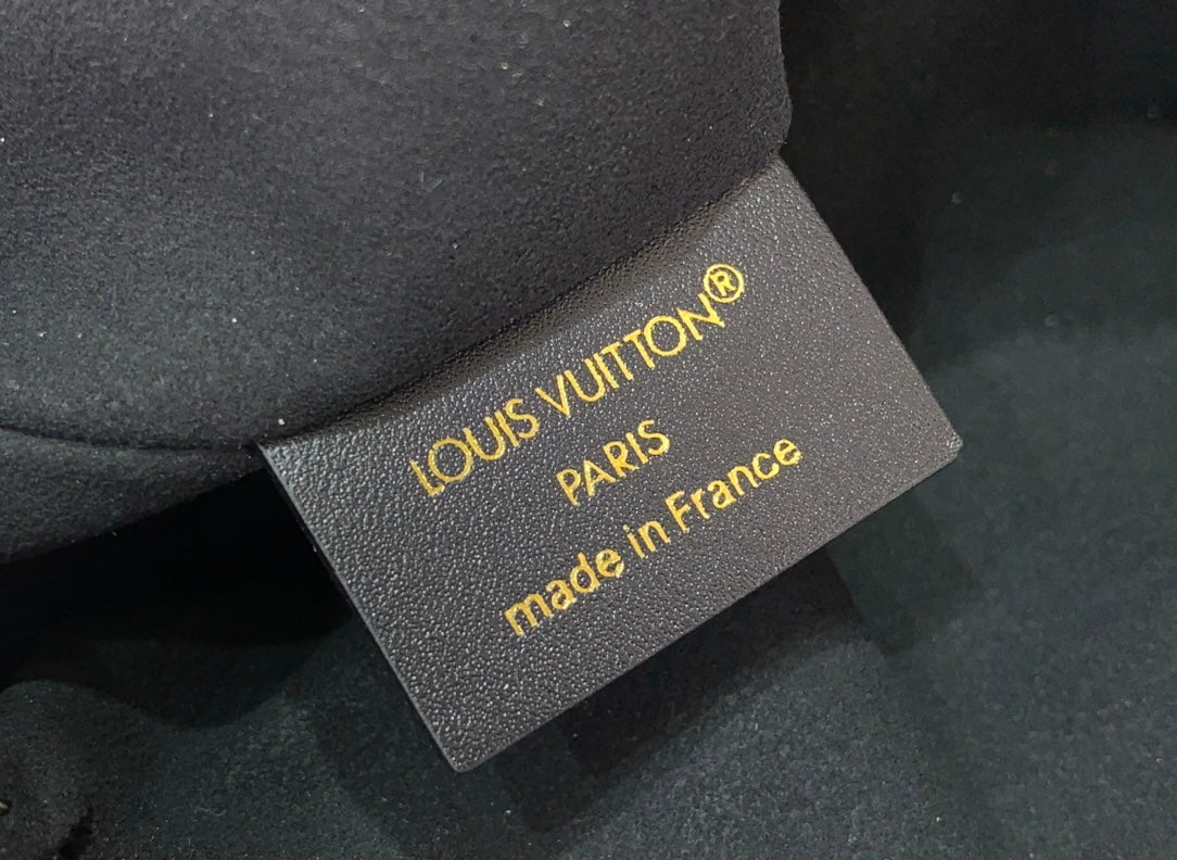 Louis Vuitton Paris made in France authenticity tag on gray fabric backing