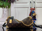 Louis Vuitton monogram crossbody bag with gold chain and dark shoulder strap, side view