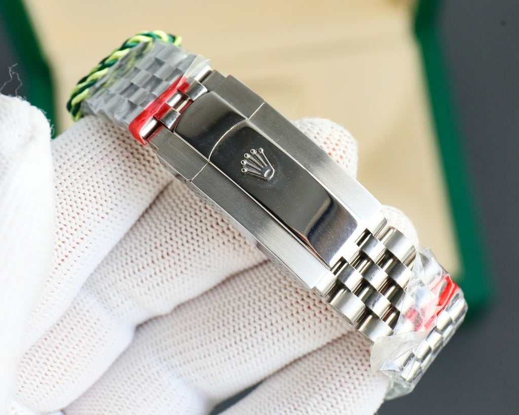 Stainless steel watch clasp with green-striped pull and engraved emblem