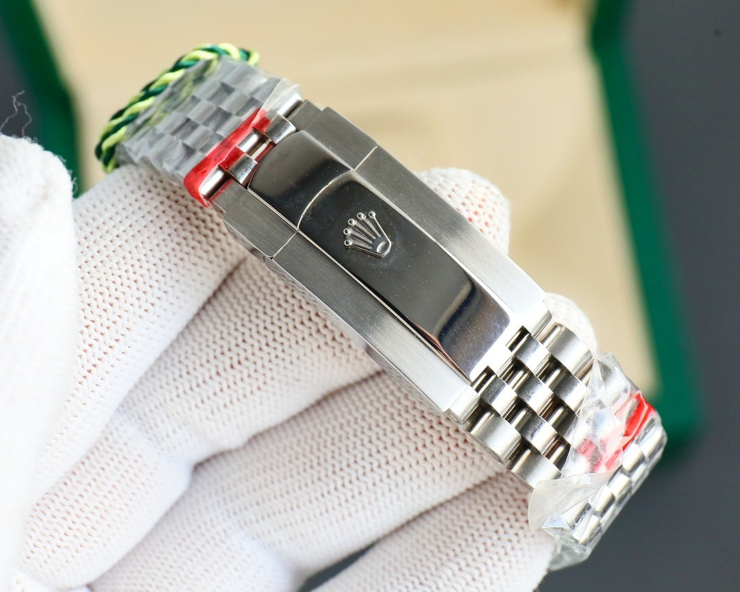 Stainless steel watch clasp with green-striped pull and engraved emblem
