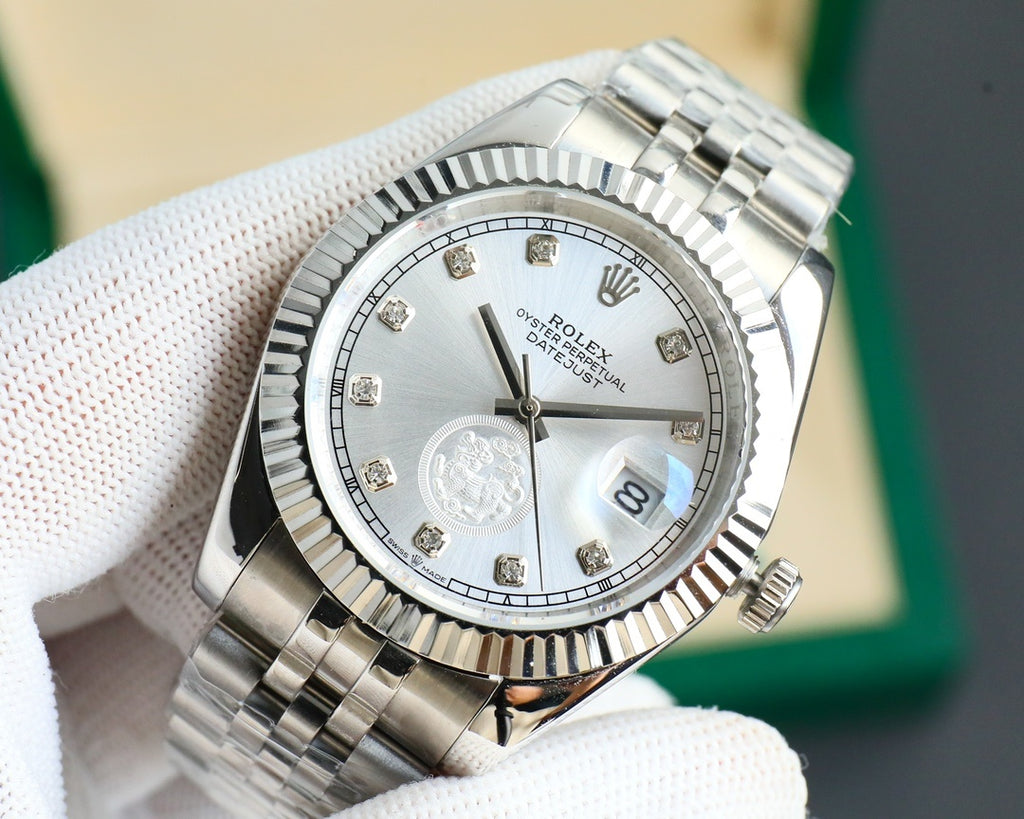 Rolex Datejust wristwatch close-up, silver dial with gold markers and date lens