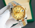 Two-tone wristwatch with gold dial and gold bezel, metal bracelet on hand