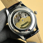 Rolex wristwatch open case back with gold-toned internal movement details