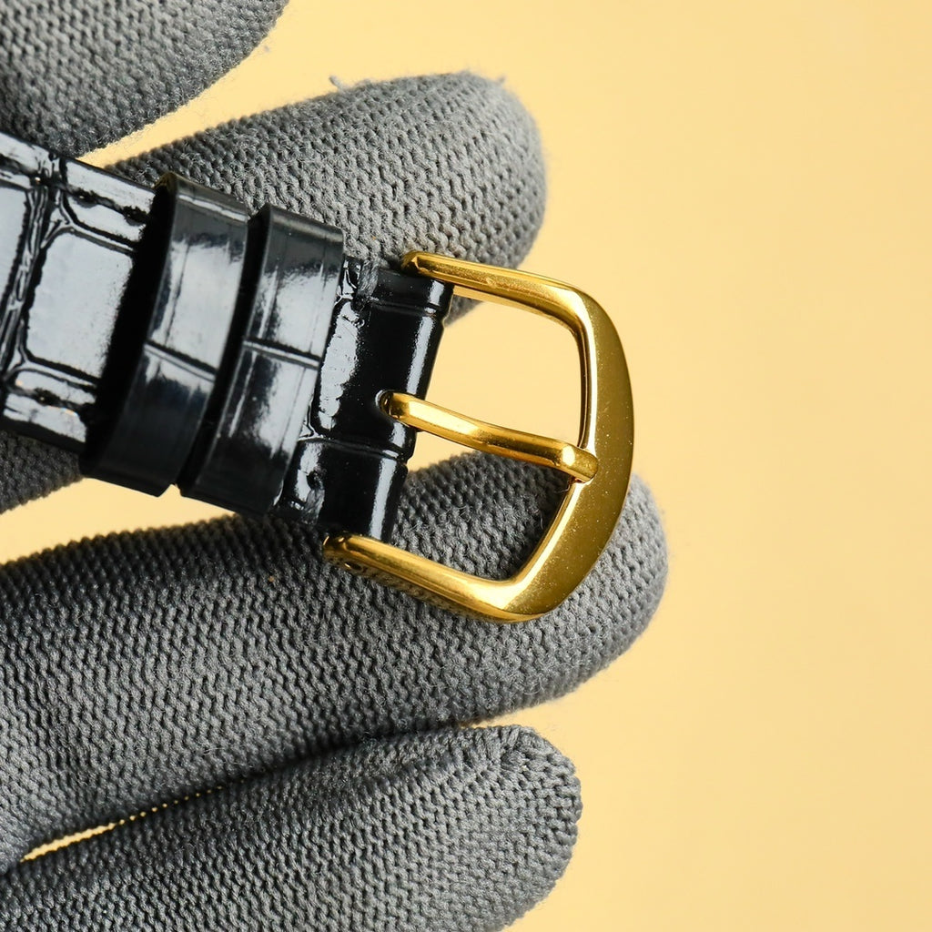 Rolex wrist watch: black leather strap with gold-tone buckle