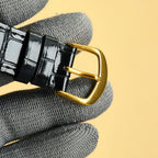 Rolex wrist watch: black leather strap with gold-tone buckle
