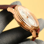 Gold-tone Datejust wristwatch side profile with crown and brown leather strap