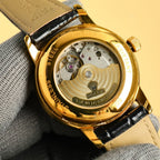 Rolex Datejust gold caseback with visible movement and black leather strap