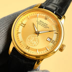 Rolex Datejust gold wristwatch with champagne-gold dial, black leather strap