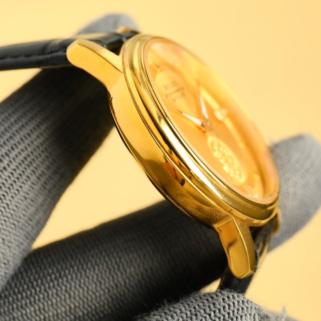 Rolex Datejust gold watch case profile on black leather strap
