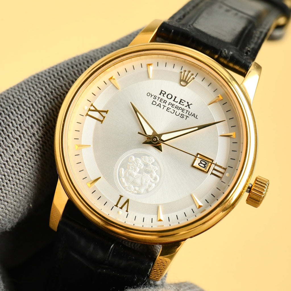 Rolex Datejust gold wristwatch with white dial, Roman numerals, black leather strap