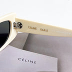 Celine sunglasses, cream temple with logo detail, dark lens visible from side.