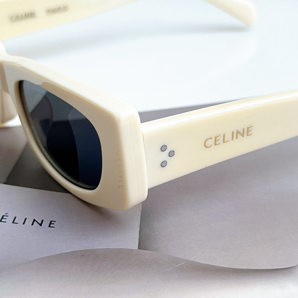 Celine sunglasses, cream frame with dark lens, close-up of side and arms.