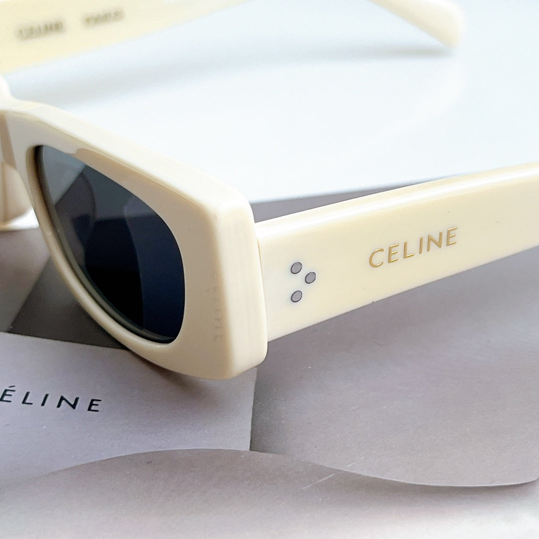 Celine sunglasses, cream frame with dark lens, close-up of side and arms.
